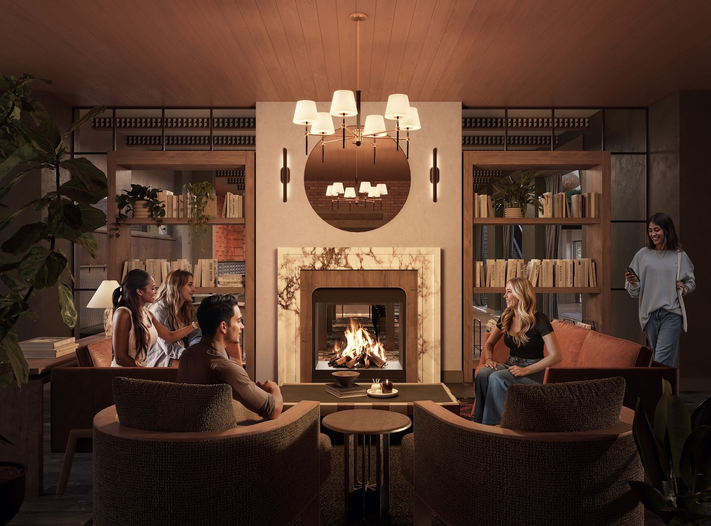 Five people relax in a cozy, elegant living room at The Jay, with a lit fireplace, modern decor, shelves with books, and warm lighting. Four sit on sofas talking while one person walks in holding drinks.
