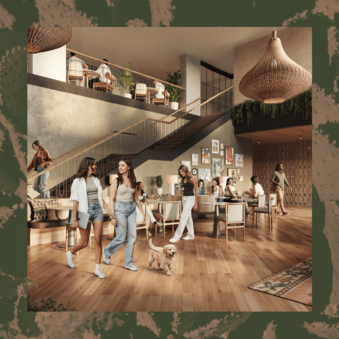 A modern, open lobby at apartments near Texas A&M with wood floors, a staircase, and people socializing. Two women walk a small dog while others sit at tables. Warm lighting, indoor plants, and wall art create a welcoming, stylish atmosphere.