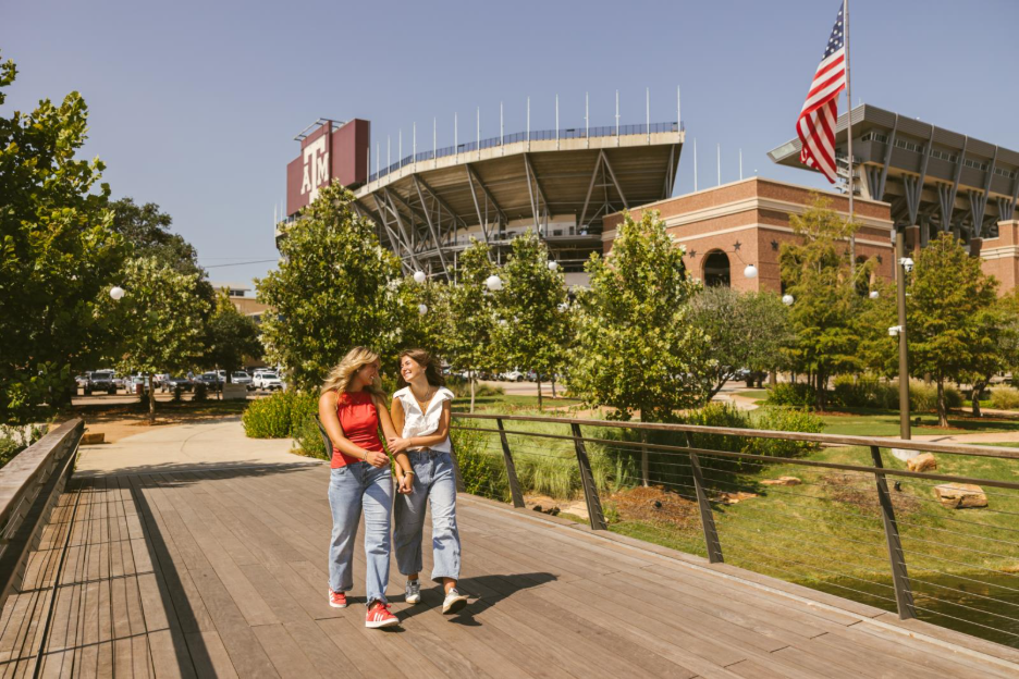 Texas A&M students walk on-campus in front of Kyle Field in College Station.