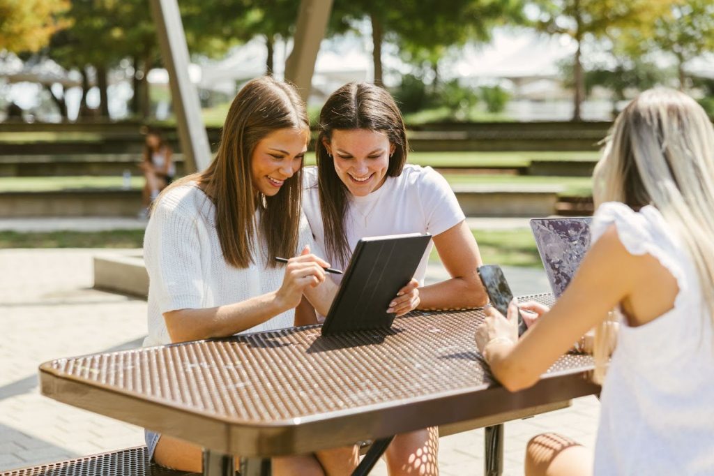 Texas A&M students work outside on campus.