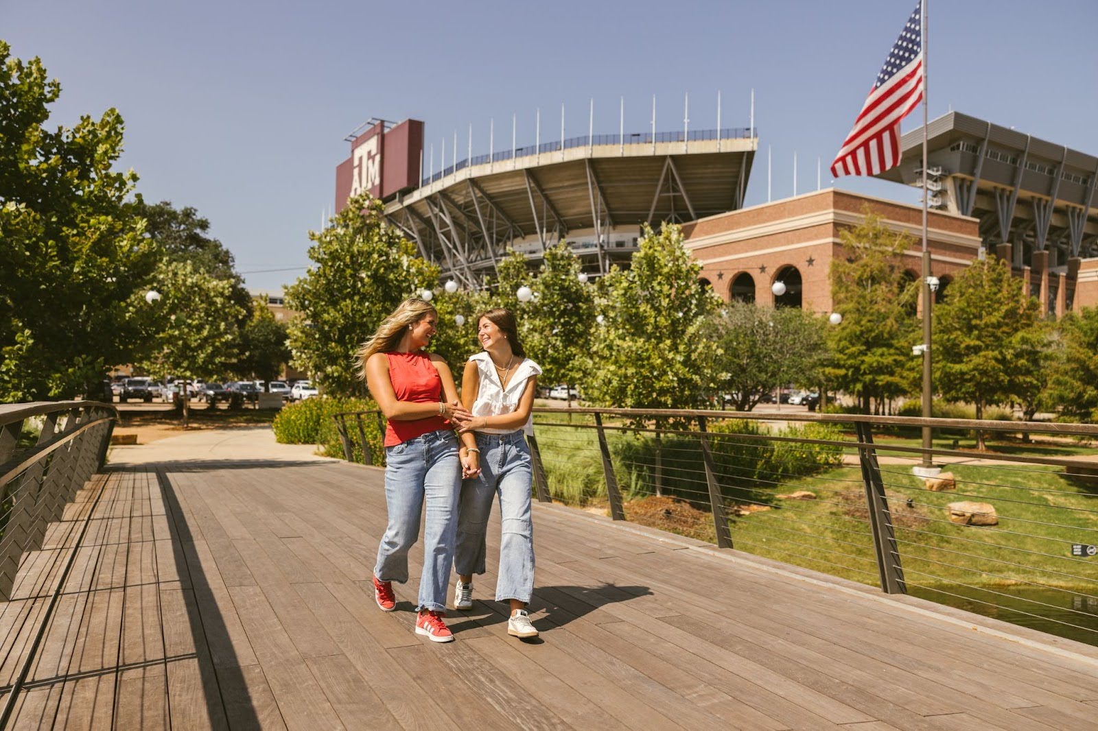 Students walk on Texas A&M campus next to Kyle Field.