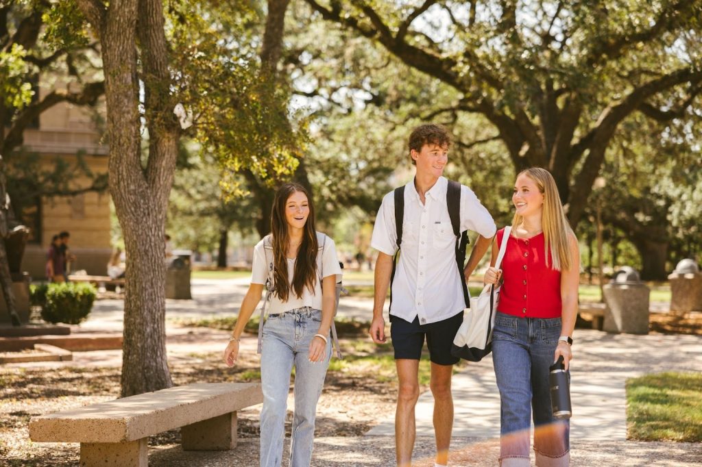Texas A&M students walking on TAMU campus.