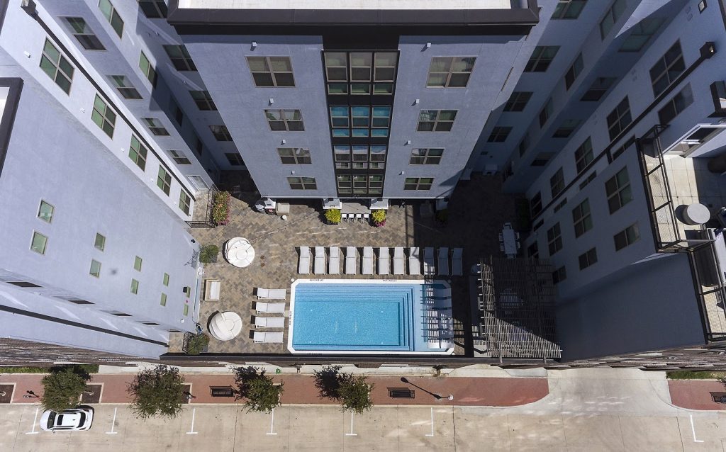 Drone view of the rooftop pool and courtyard at The Hudson in College Station.