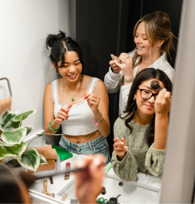 Roommates freshen up in their unit’s apartment bathroom at The Jay in College Station.