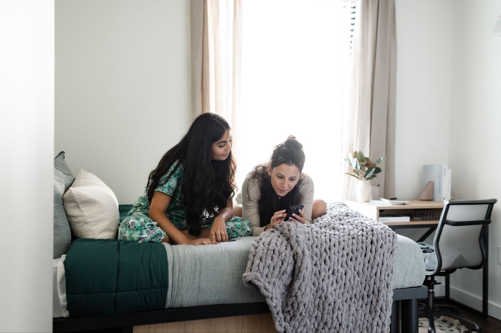 Texas A&M students sit together in their off-campus apartment in College Station.