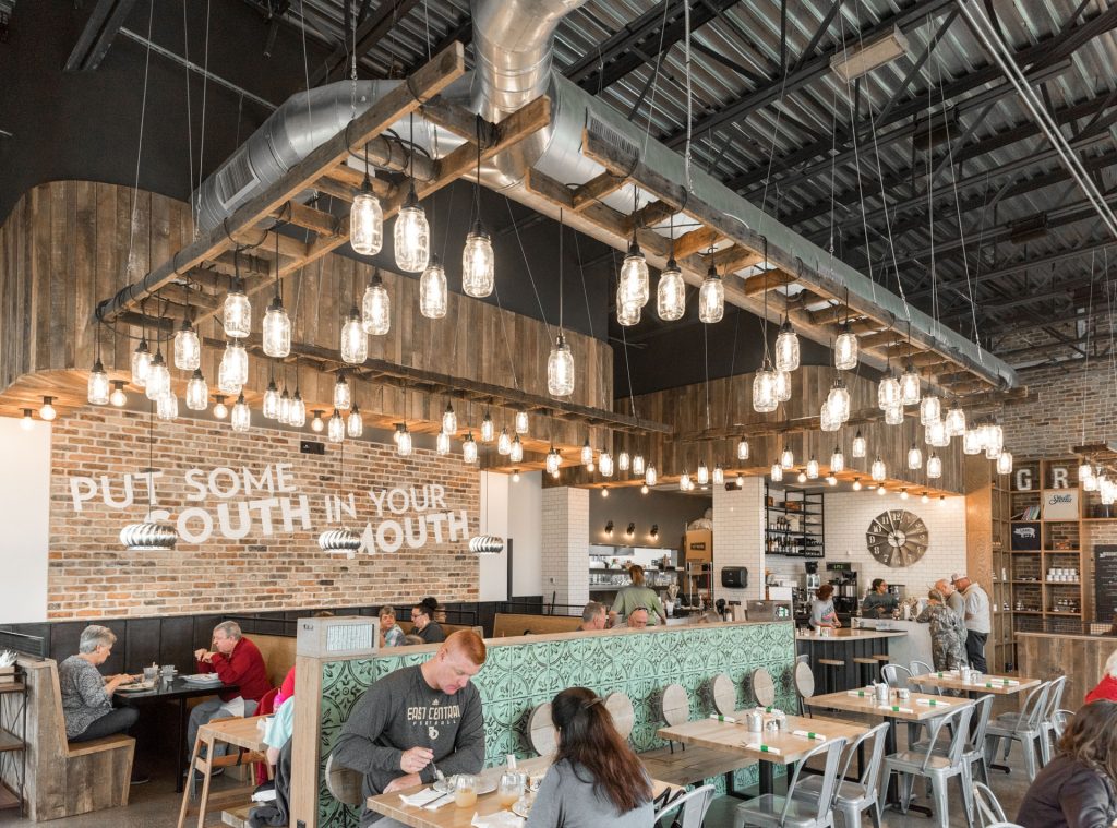 A charming, rustic industrial interior with booth style seating at Stella Southern Cafe, a brunch spot in College Station.