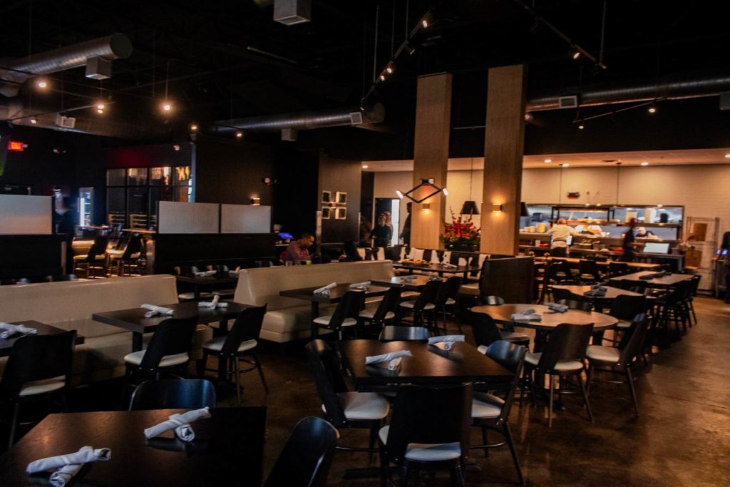A variety of seating is offered at 1860 Italia, with a spacious interior topped with high ceilings and dim lighting.
