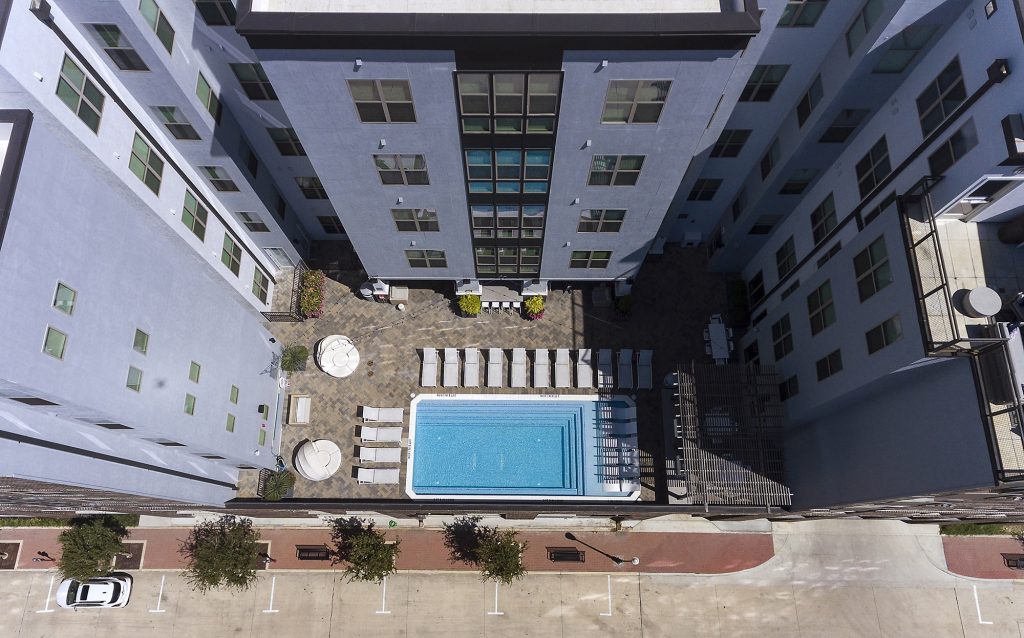 Drone view of the rooftop pool and courtyard at The Hudson in College Station.