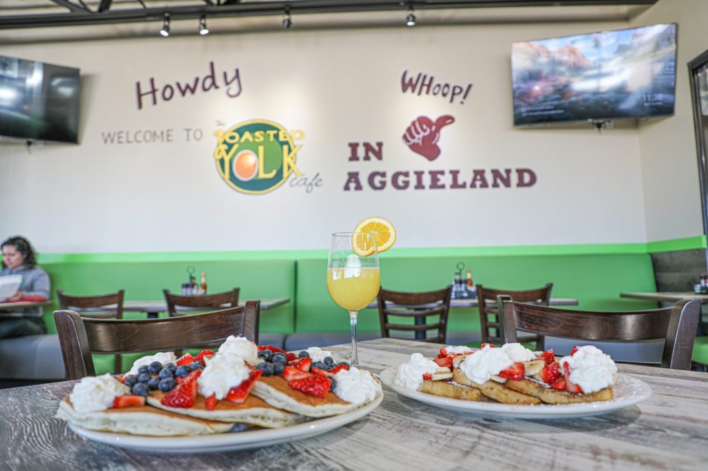 Aggie-inspired wall at The Toasted Yolk Cafe brunch spot in College Station.